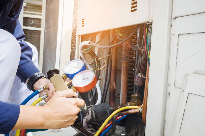 technician is checking air conditioner